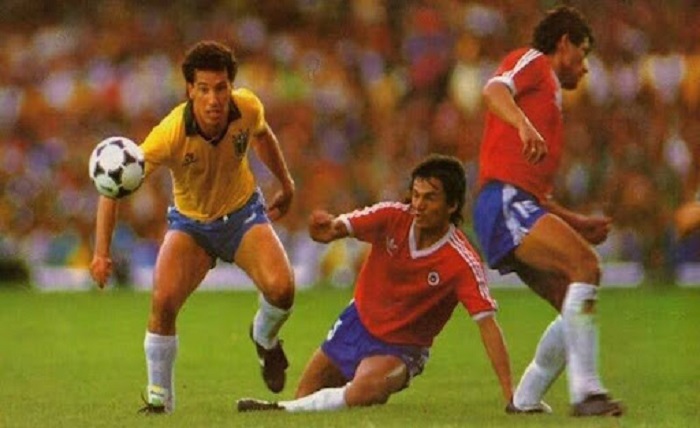 Chile’s 1989 World Cup qualifier scandal shocked football as a goalkeeper faked an injury with a razor blade against Brazil. Relive the controversy. Chile 1989 – Goalkeeper’s Razor Blade Scandal vs Brazil Football has seen many controversies, but few match the chaos of Chile’s World Cup qualifier in 1989. During a heated clash with Brazil, goalkeeper Roberto Rojas used a hidden razor blade to fake an injury and stop the match. This shocking scandal is still remembered today, and Xoilac TV brings back the full story behind one of football’s darkest nights. The high-stakes match in Rio de Janeiro World Cup qualifiers are always intense, but the atmosphere in 1989 was on another level. Brazil and Chile were fighting for a place at the 1990 World Cup, and both sides carried heavy pressure into the decisive match. Brazil and Chile battling for a place at the 1990 World Cup Brazil and Chile’s rivalry in World Cup qualifiers Brazil and Chile had a history of dramatic encounters. Meetings between the two sides often carried national pride beyond just football. For Chile, winning in Rio de Janeiro meant proving themselves on one of the biggest stages in the world. The rivalry had grown with every qualifying campaign. Fans knew that emotions would run high, and the 1989 clash was expected to be fierce from the start. Chile’s desperate need for a victory to keep their hopes alive The table situation left Chile with little choice but to push for a win. A draw would not be enough to secure qualification. This desperation shaped their aggressive approach on the pitch. The Chilean squad fought for every ball, but Brazil’s quality gave them control. The pressure mounted with every passing minute as Chile’s chance of survival slipped away. Must Read: Cakhia Soccer livescore, results, detailed statistics, free tips The intense atmosphere at Maracanã Stadium The Maracanã Stadium was packed with passionate Brazilian supporters. More than 100,000 fans filled the stands, creating a thunderous environment. For Chile, it was one of the most intimidating settings imaginable. As Brazil scored to take the lead, the crowd erupted. Chile’s players felt the weight of the moment, and frustration began to show. The tension inside the stadium was only building toward what would become a shocking twist. The razor blade incident that stunned the world As the game moved forward, Chile fell behind and their qualification hopes looked nearly over. It was at this breaking point that goalkeeper Roberto Rojas carried out an extraordinary plan. Chile’s keeper and his remarkable scheme Roberto Rojas and his hidden blade plan Rojas was under heavy pressure as Chile’s goalkeeper. He knew that elimination would mean disappointment for the entire nation. In his desperation, he resorted to deception. By cutting himself with the razor blade, he attempted to make it appear that the flare thrown by fans had caused a serious injury. This was meant to force the match into suspension. The moment of chaos after the flare landed When Rojas collapsed on the field, panic swept across the stadium. Chile’s players rushed toward him, claiming that their goalkeeper had been struck. The crowd was silenced as confusion spread. Officials gathered to assess the situation, and television cameras captured dramatic images of blood on Rojas’s face. For a moment, the narrative of fan violence seemed believable. How the fake injury fooled officials and shocked fans The match was abandoned as Rojas was carried off, surrounded by teammates. Chile’s officials argued that the game should be awarded in their favor due to unsafe conditions. Many fans around the world were shocked. A World Cup qualifier had ended in chaos, with uncertainty hanging over the result. For a brief time, Chile seemed to have created an escape through Rojas’s act. Fallout and lasting impact on Chilean football The scandal did not end when the match stopped. FIFA immediately launched an investigation into what had really happened on the pitch. It soon became clear that the truth was far more damaging than anyone had imagined. FIFA’s investigation and the shocking truth revealed FIFA analyzed the incident with detailed video review and medical examinations. Witnesses confirmed that the wound was self-inflicted. The razor blade hidden in Rojas’s glove was the key piece of evidence. The governing body concluded that Chile’s appeal had no ground. Instead of being victims, they had orchestrated an attempt to manipulate the match outcome. Punishments handed to Rojas, Chile’s team, and officials The punishment was swift and severe. Rojas received a lifetime ban from football, effectively ending his career. Team officials who had supported the deception were also disciplined. Chile as a national team suffered as well. They were banned from participating in the qualifiers for the 1994 World Cup, a penalty that hurt the nation’s football development. How the scandal changed Chile’s reputation in football For years, Chile’s football reputation was stained by the scandal. Other nations viewed them with suspicion, and rebuilding trust took time. Fans at home were left divided between anger and shame. The event became a reminder of how desperation can lead to destructive decisions. Instead of securing a place at the World Cup, Chile faced exclusion and embarrassment on the global stage. Conclusion The Chile 1989 scandal remains one of football’s most notorious moments. A goalkeeper’s desperate act with a hidden razor blade turned a qualifier into a worldwide controversy. The punishment reshaped Chilean football for years. Even today, fans recall that night in Rio as a lesson on the dangers of crossing the line between competition and dishonesty.